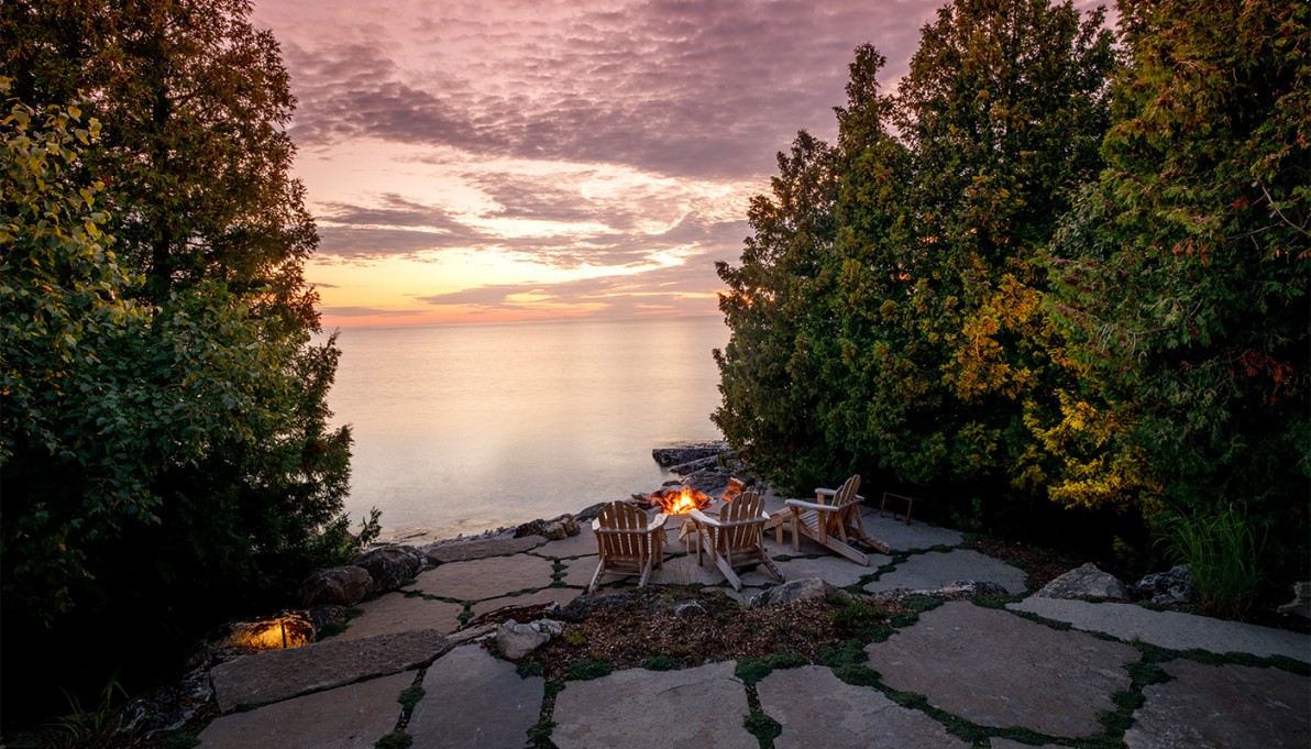 lake view with fire and chairs