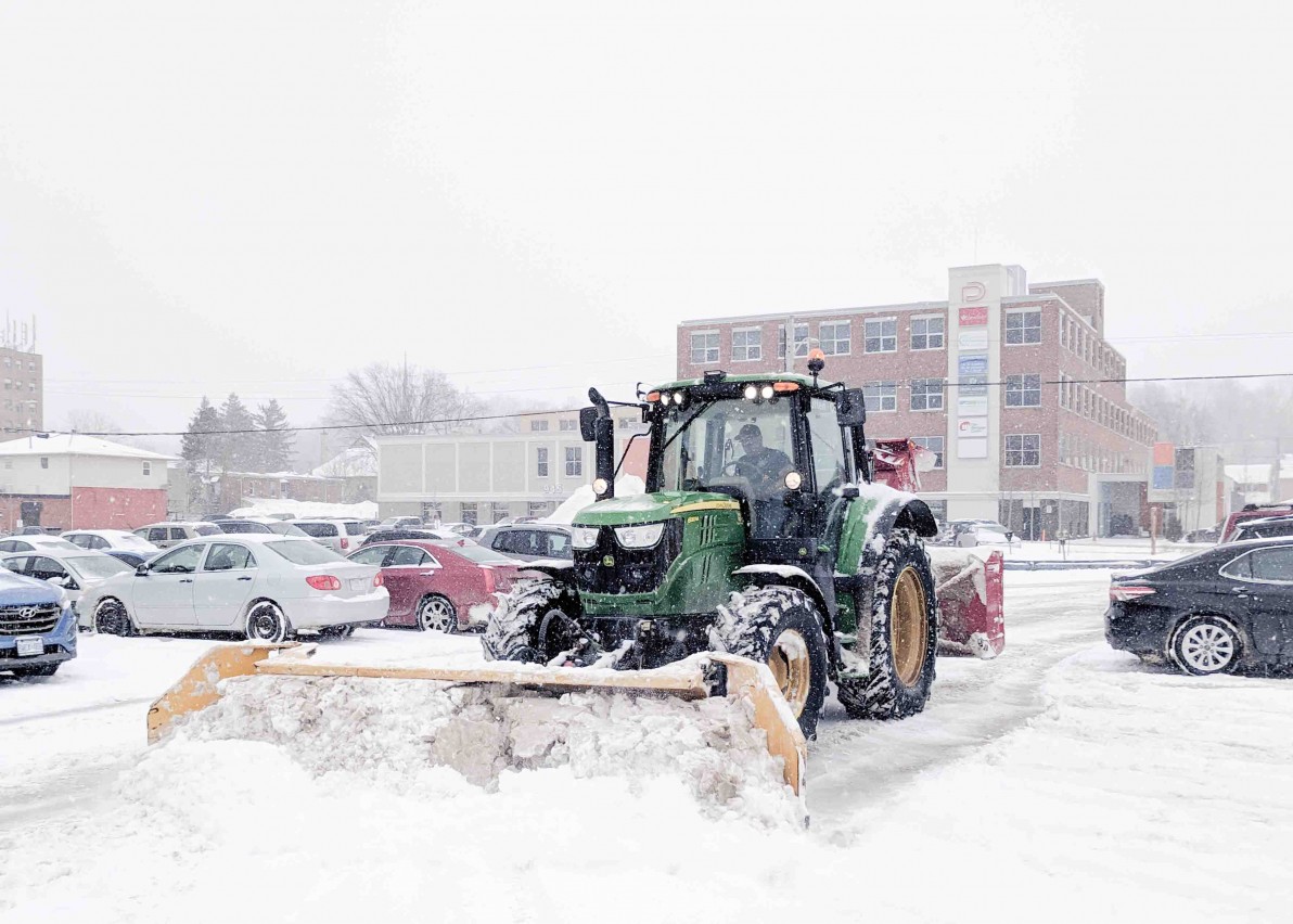Snow plow tractor on parking lots
