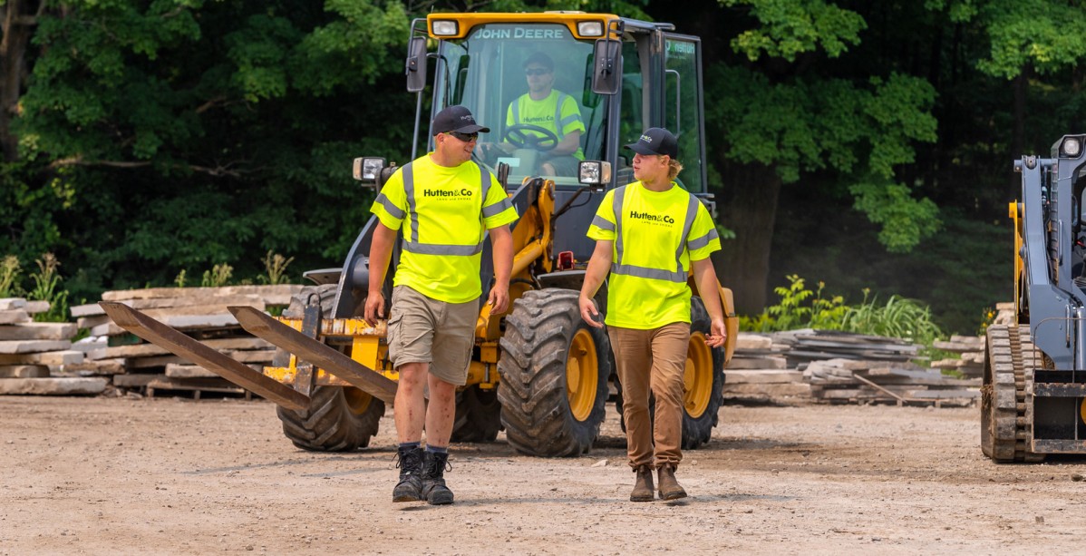 Two employees talking at a job site.