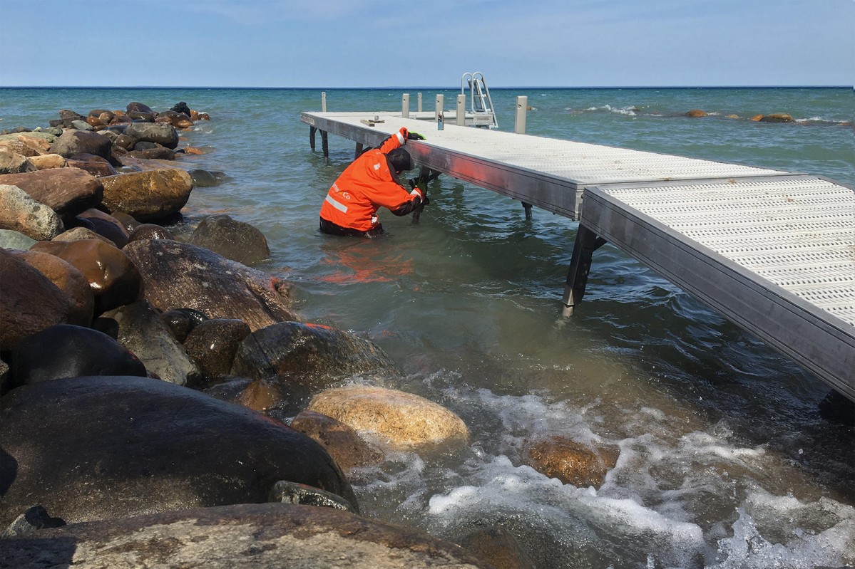 Employee installing a special feature on a dock.