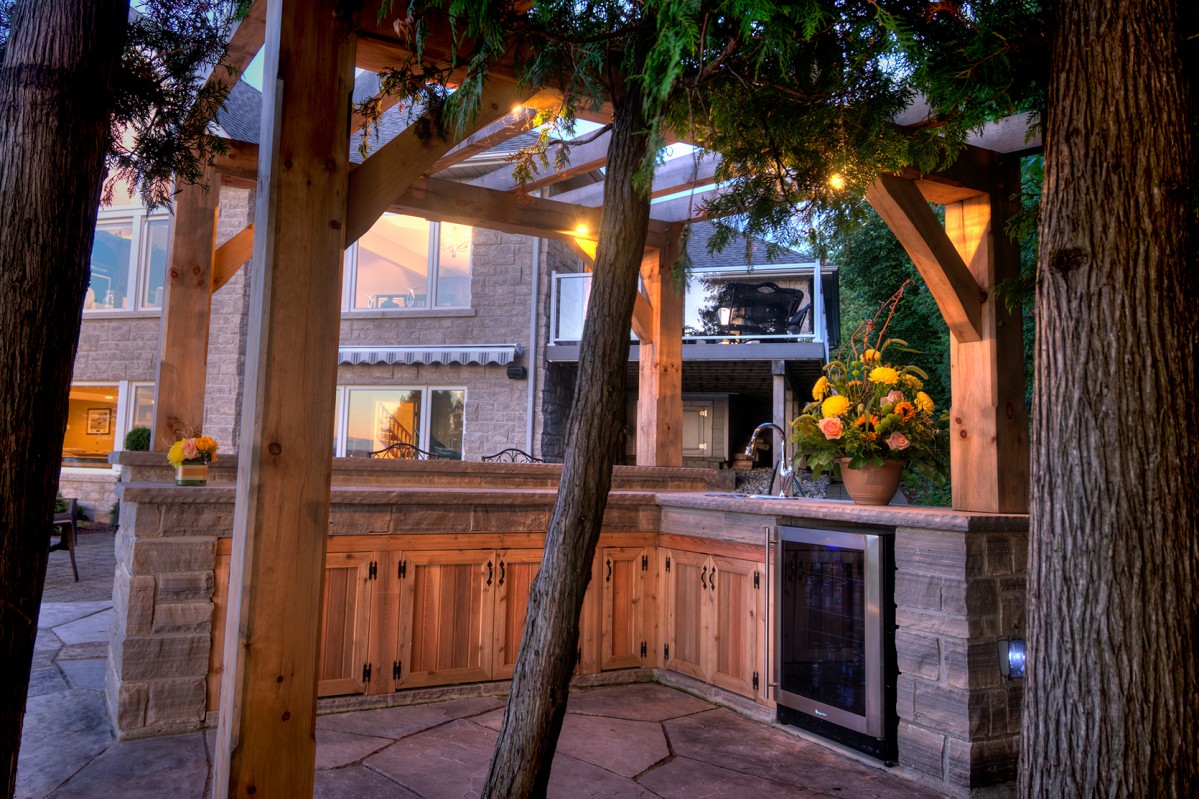 A natural stone kitchen in a backyard setting.