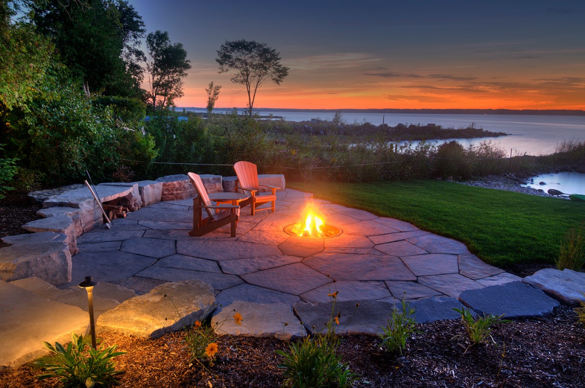 fire pit by lake at sunset